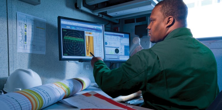 OilRecon USA field engineer monitoring real-time production data